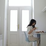 Woman sitting at a desk using her laptop. Photo courtesy of Jessica Ticozzelli on Pexels.