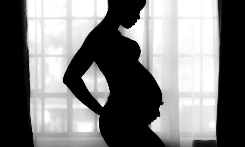 photo of pregnant women in black silhouette
