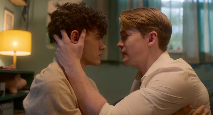 Sad image of a queer couple in Young Royals staring sadly into one anothers eyes.