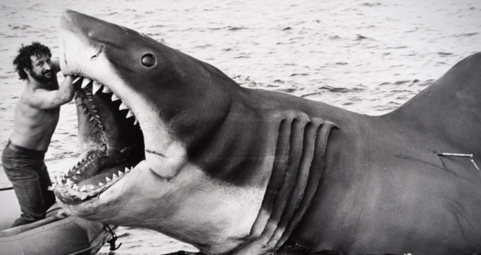 Image of the puppet shark from Jaws, with Steven Spielberg holding its mouth open